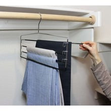 Metal 4-tier pant and skirt hanger with folded pants on four stacked bars