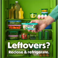 Wet dog food tub being placed in a refrigerator, resealable container