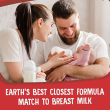 Baby drinking as parents hold bottle; closest formula match to breast milk