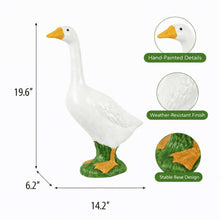 White goose statue with yellow beak, green feet, and stable base design.