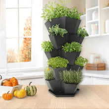 5-tier stackable planter holding green herbs and flowers in black pots