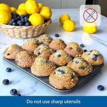 Gray nonstick muffin pan holding assorted baked muffins in cups