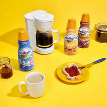 French Vanilla creamer singles with coffee cup, creamer bottles, and spoon on plate