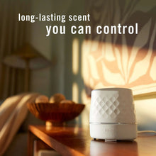 White Febreze Plug oil warmer on a tabletop with geometric top