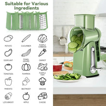 Green rotary cheese grater next to plate of shredded cucumber and zucchini