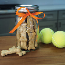 Ball wide-mouth mason jar with metal lid and band, tied with orange ribbon, clear glass.