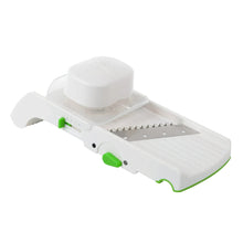 White multi slicer with blade plate and green buttons along the base