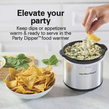 Hamilton Beach party dipper food warmer with black lid and handles on a table