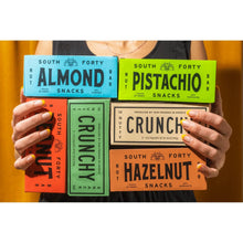 Assorted nut snack boxes held together, including pistachio