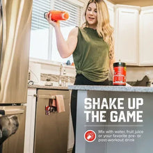 Creatine powder bottle on kitchen counter next to blender and woman in green top