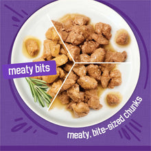 Gravy wet cat food meaty chunks on white plate with small gravy pools