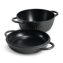 Two-piece black enameled Dutch oven set with shallow and deep pots, each with handles.