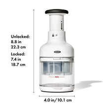 White food chopper with clear chopping container and black top knob