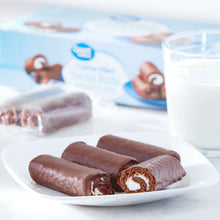 Crème-filled Swiss roll snack cakes on a plate, cocoa-brown with white swirl