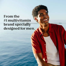 Smiling man in a red shirt, lifestyle ad for One A Day men’s multivitamin gummies