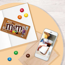 Caramel cold brew candy pack with M&M's candies and a smartphone showing the drink