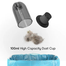 Cordless vacuum with clear dust cup and brush attachment, plus loose debris inside