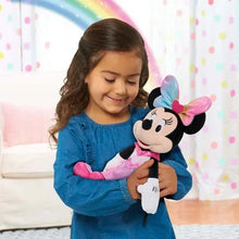 Minnie Mouse plush with rainbow bow and pink heart dress, held by a child