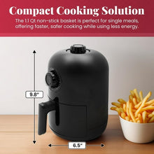 Compact black air fryer on countertop with side handle and front control dial.