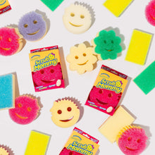 Mixed smile-shaped cleaning sponges and retail boxes, pink and yellow scrub face shapes