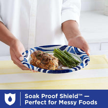 Disposable 10-inch paper plate with blue wave rim holding steak and asparagus