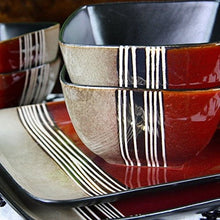 Stacked stoneware bowls and a tray in red and beige with black vertical stripe glaze