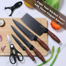 Set of textured black kitchen knives on a light cutting board with scissors and peeler