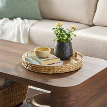 Natural woven water hyacinth tray with clear insert, oval shape on a table