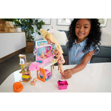Pink pet boutique playset with counter, pet figures, and shopping-style accessories