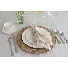 Set of white porcelain side plates with embossed floral rim, stacked for serving