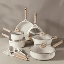 White nonstick cookware set with glass lids, wood handles, and stacked pots