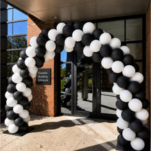 White latex balloons in a black-and-white balloon arch