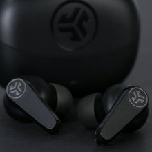 Black in-ear true wireless earbuds close-up, showing earbud logos and pair