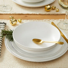 White stoneware bowl and plate with gold rim and speckled finish