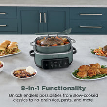 Sage green multi-cooker with lid open, serving pot on countertop