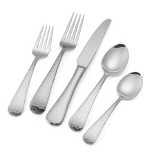 Close-up of hammered stainless steel flatware with forks, knife, and spoons