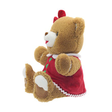 Brown teddy bear plush in red dress with green buttons and white trim, back-to-side view