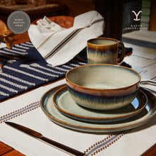 Set of ceramic dinner plates stacked; seafoam glaze with speckled brown rim
