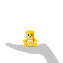 Yellow bear micro plush seated with star-shaped belly emblem and smile