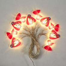 Unicorn string lights with glowing bulbs and pink bow cutouts on silver wire