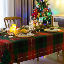 Rectangle plaid tablecloth in green and red draped over dining table