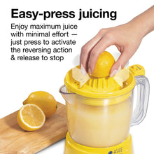 Electric citrus juicer with yellow reamer, clear pitcher, and hand pressing citrus