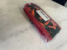 Skillet handle cover in clear plastic bag, black and red chili pepper design