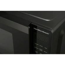 Microwave control panel close-up with Hamilton Beach logo and digital time display