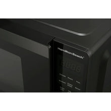 Microwave control panel close-up with digital display and Hamilton Beach logo