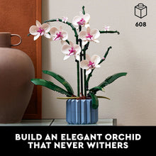 Artificial orchid building set with pink and white blossoms and green leaves in blue pot