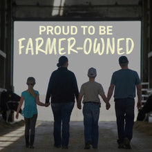 Farmers standing in front of 'Proud to be Farmer-Owned' sign