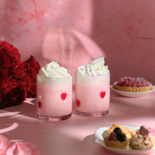 Set of 2 drinking glasses with red heart charm decals and pink candle-style contents