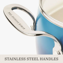 Stainless steel handle on a denim blue ceramic non-stick pot with glass lid