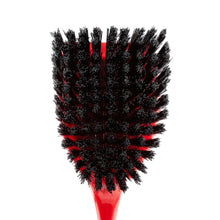 Scrub brush head with dense black bristles and red base